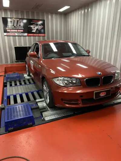 BMW 1 Series E87 copper red on the DTA Mainline dyno — ECU remap Sydney
