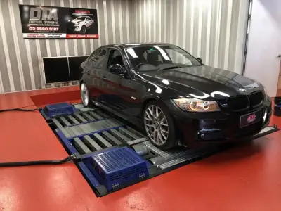 BMW 3 Series E90 black M Sport with angel eyes on the DTA dyno — ECU remap