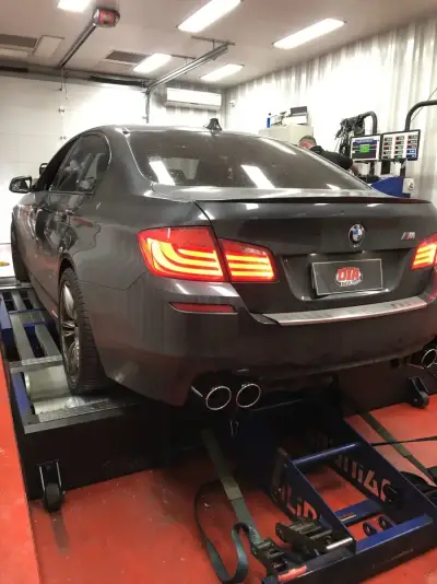 BMW 5 Series F10 M Sport charcoal — rear view on the DTA Mainline dyno, ECU remap