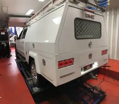 GMC Sierra white with service canopy — rear view on the DTA dyno, ECU remap