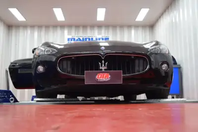 Maserati Ghibli 3L ECU remap — Maserati GranTurismo dark maroon — front grille on the DTA Mainline dyno, ECU remap