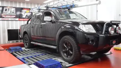 Nissan Navara D40 black with bull bar and roof rack — ECU remap Sydney