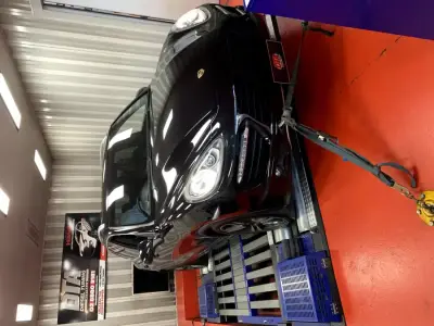 Porsche Cayenne 958 black — front 3/4 on the DTA Mainline dyno, ECU remap Sydney