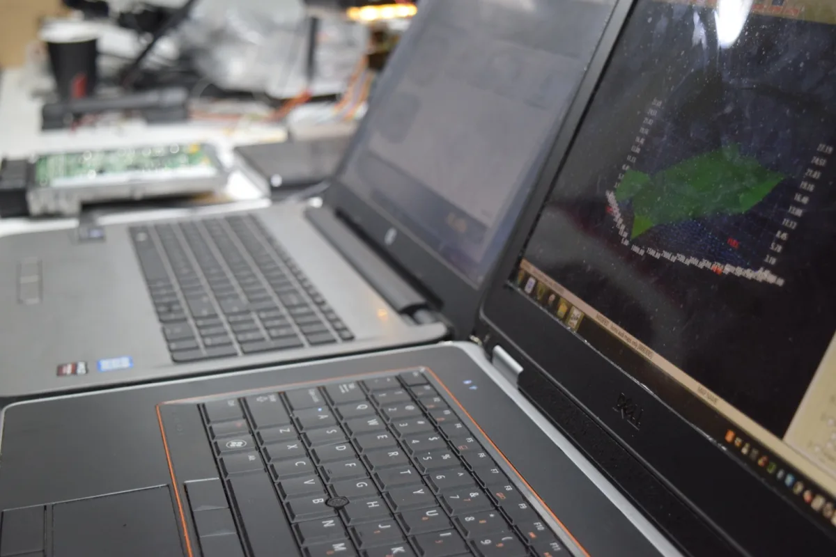 DTA technician working on an open ECU with DTA Custom ECU Remap equipment